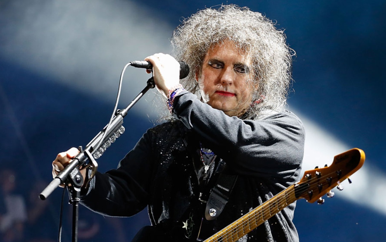 Robert Smith playing guitar with The Twilight Sad on stage.