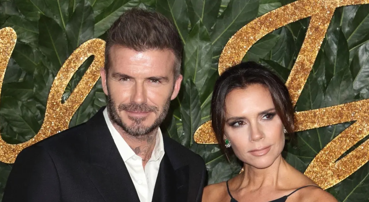 Victoria and David Beckham pose together at a charity event in London.