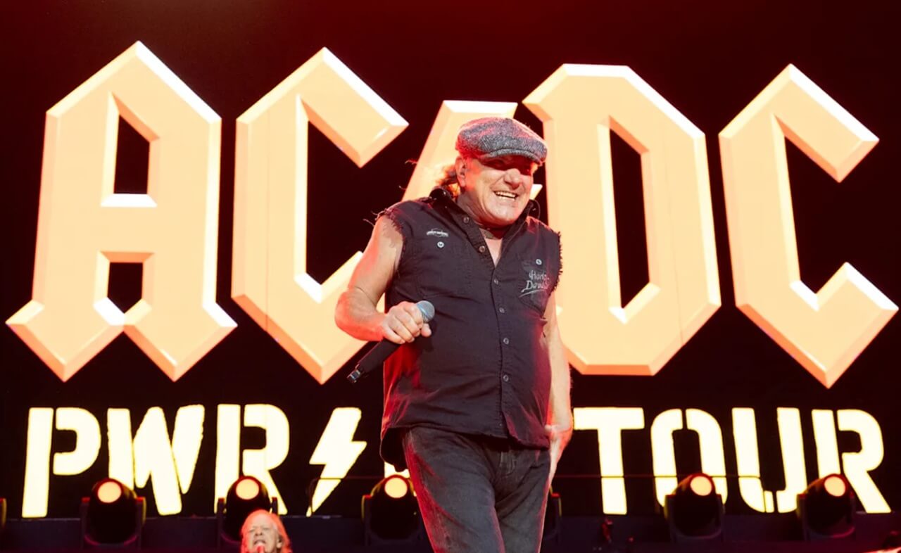 AC/DC band members performing under red and black lighting during the Power Up Tour.