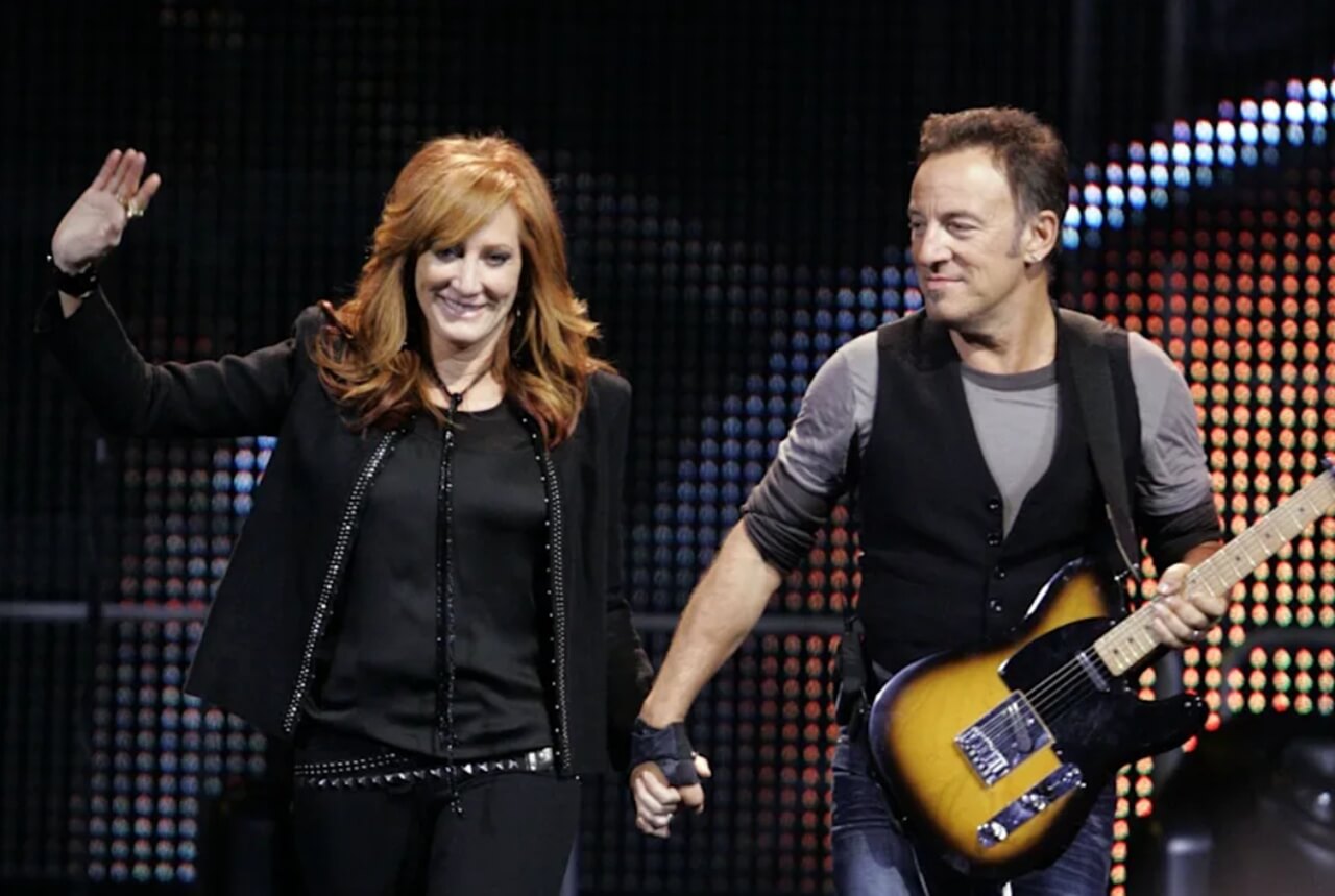 Bruce Springsteen and Patti Scialfa performing at a Christmas-themed event.