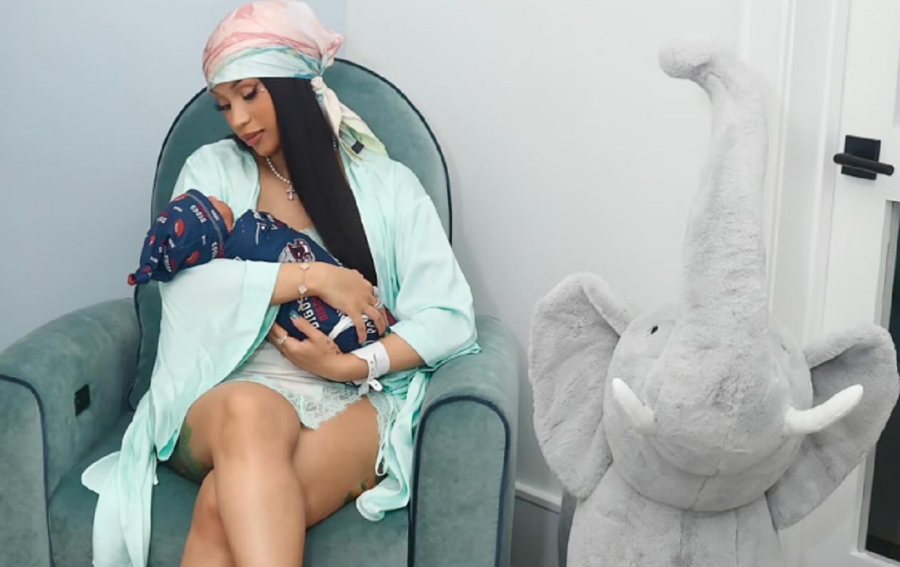 Cardi B cradling her newborn son in a mint-green silk bathrobe, sparking engagement rumors with a diamond ring.