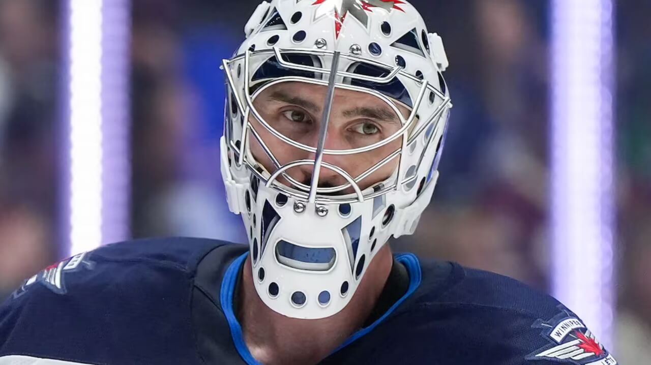Connor Hellebuyck leaving the ice following a game before knee surgery news