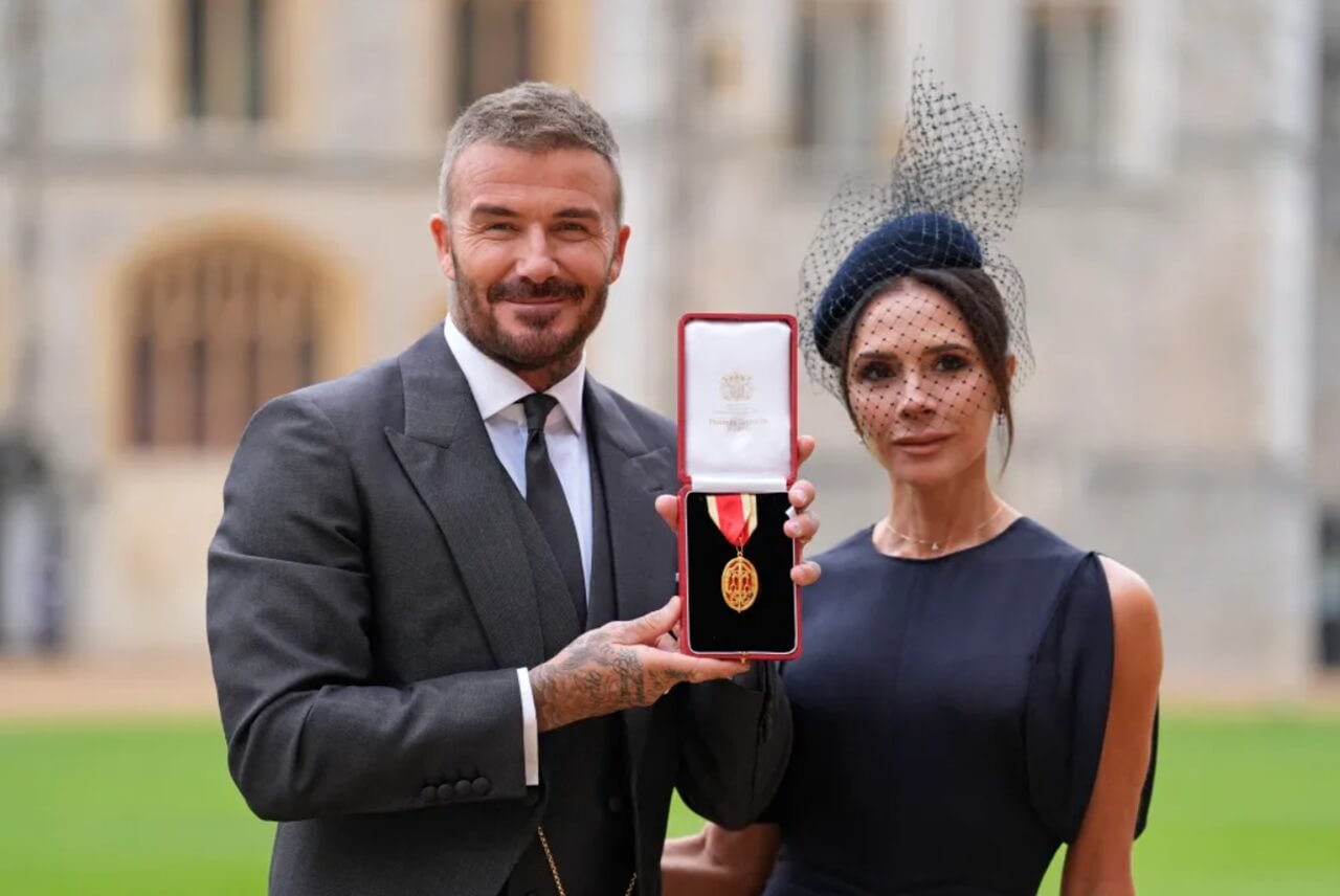 King Charles knighting David Beckham at Windsor Castle ceremony.