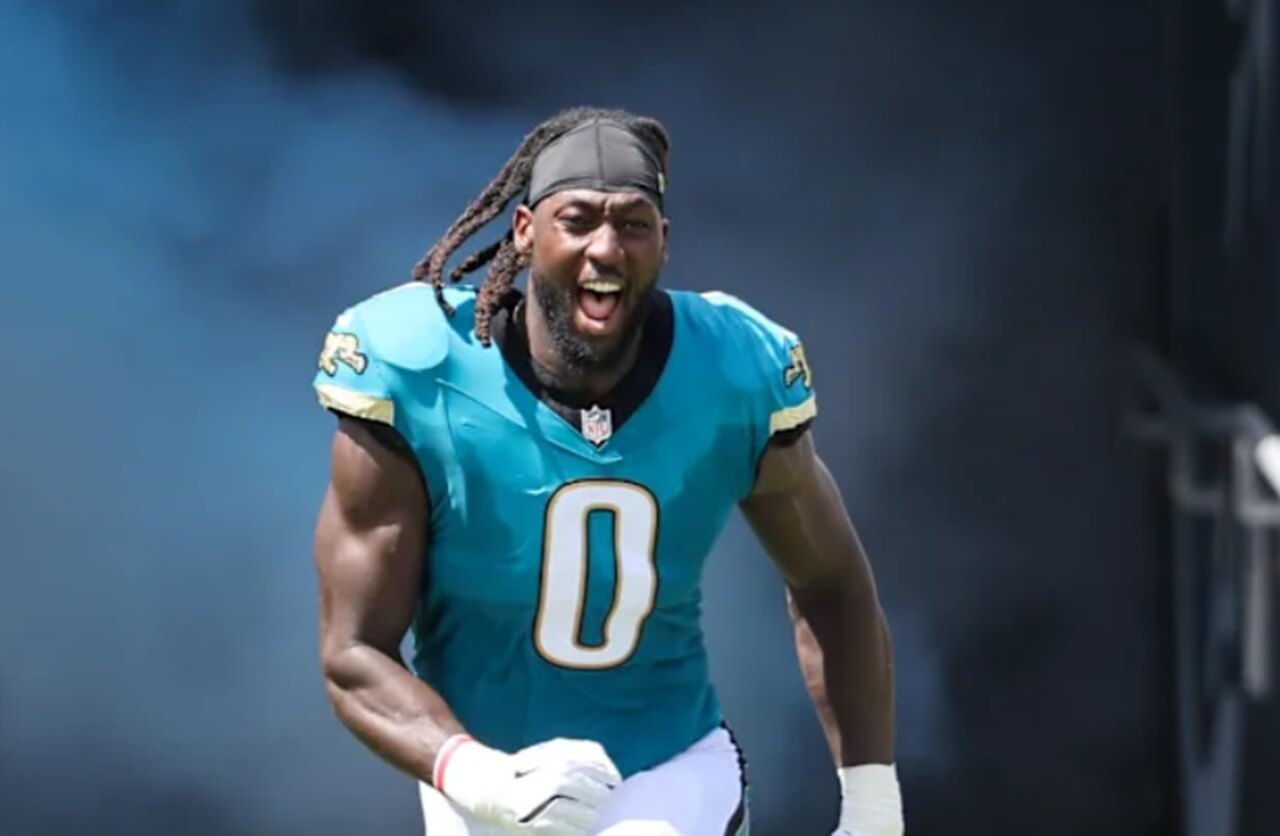 Devin Lloyd celebrates interception return touchdown in Jaguars uniform.