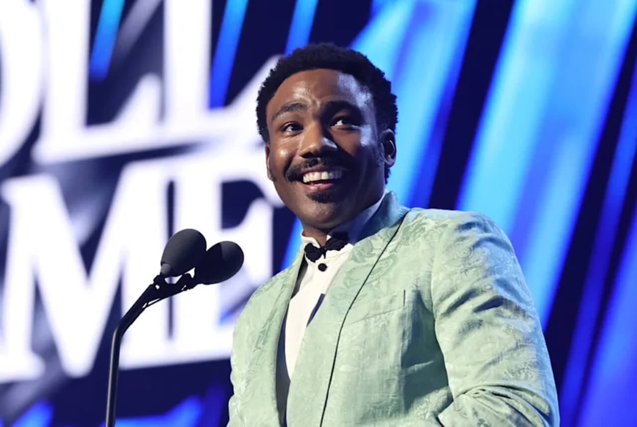 Donald Glover addressing fans onstage during his 2024 tour.