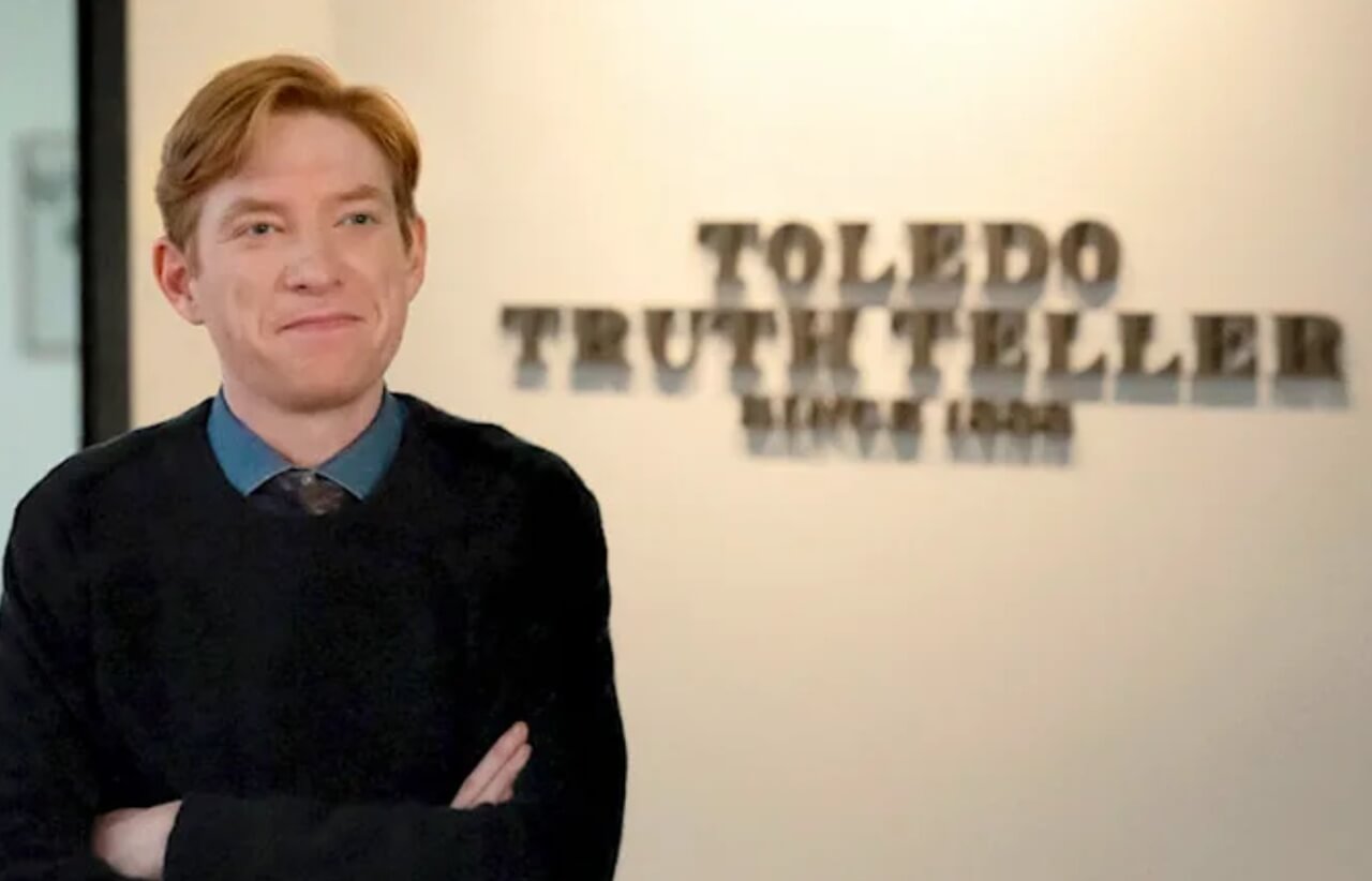 The Paper premiere scene showing Domhnall Gleeson as Ned Sampson at the Truth Teller newsroom.