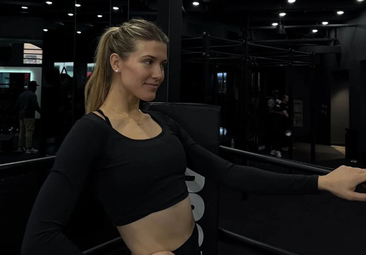 Genie Bouchard flaunting toned abs in a sporty black crop top during her NYC gym workout.