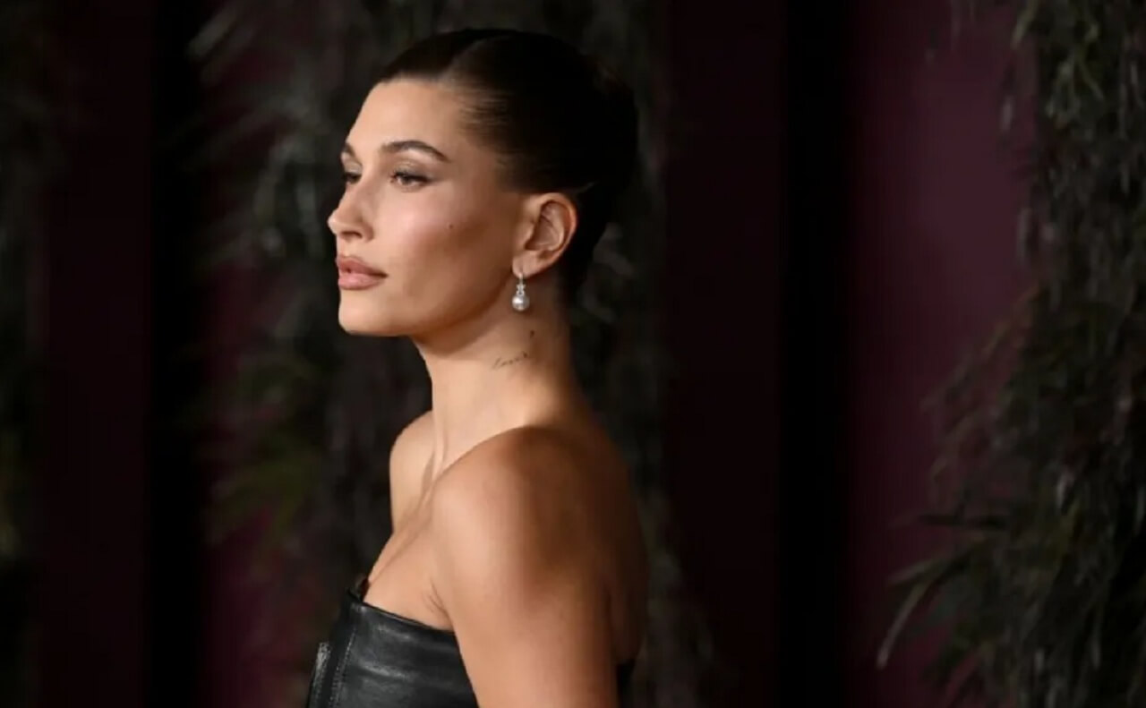 Hailey Bieber mirror selfie in black dress and sleek bun