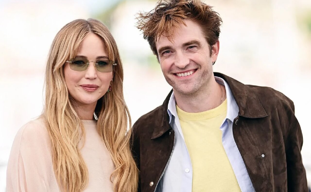 Jennifer Lawrence and Robert Pattinson pose at Die My Love premiere in New York.