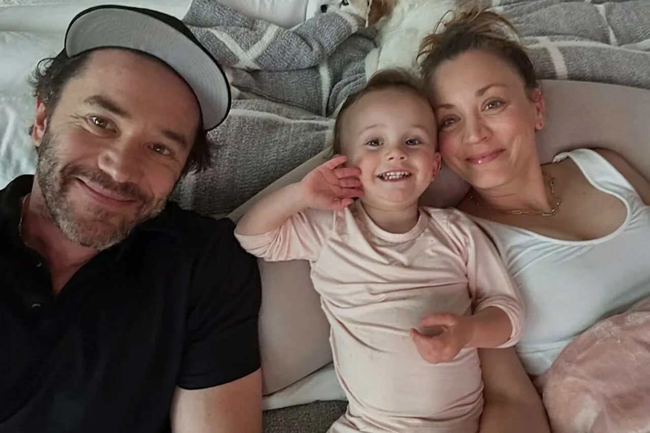 Kaley Cuoco, Tom Pelphrey, and daughter Matilda smiling in family portrait.