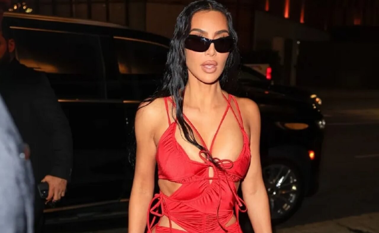 Kim Kardashian stuns in a fiery red backless gown while promoting All’s Fair in Rio de Janeiro.