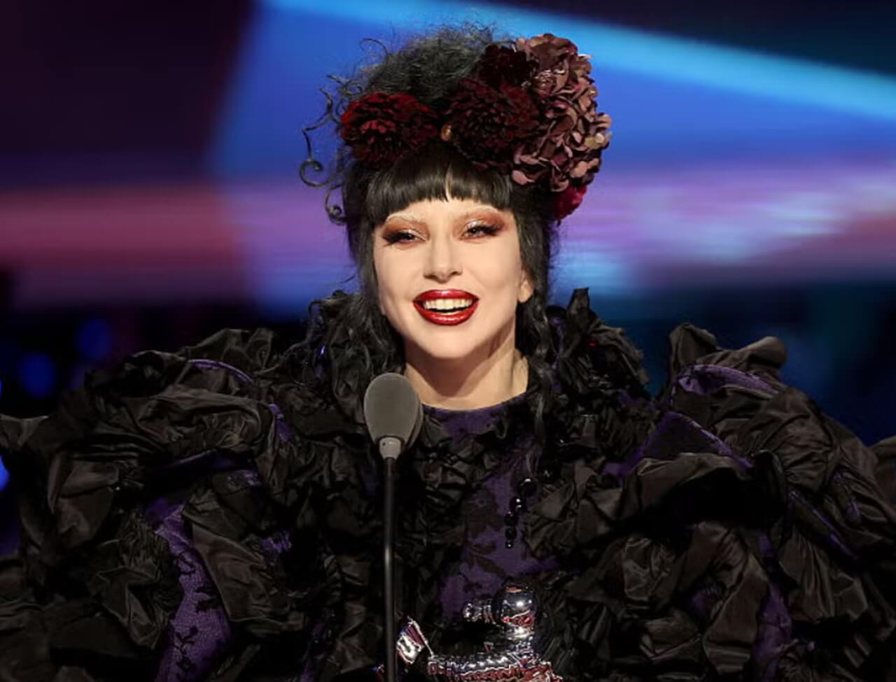 Lady Gaga in Paris debuting jet-black hair and Tom Ford suit.