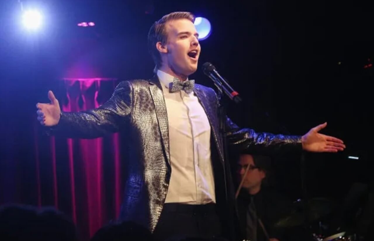 Mark William singing onstage at Green Room 42 during live album performance.