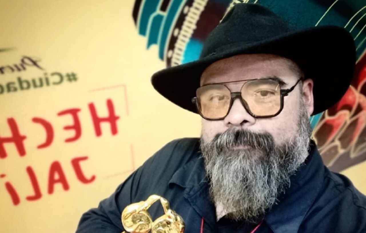 Mexican filmmaker Pancho Rodríguez smiling at a film event, remembered for his work on Encrucijada.