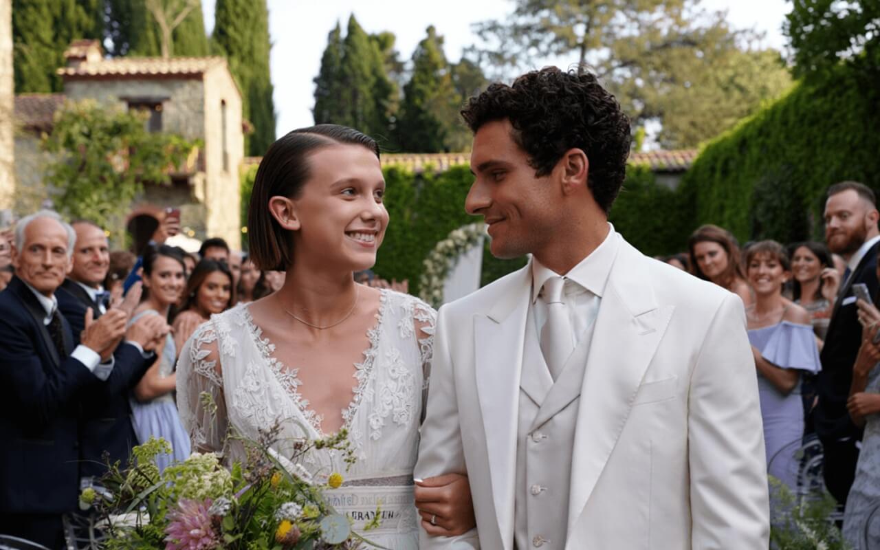 Millie Bobby Brown and Jake Bongiovi posing together at a public event before their wedding.