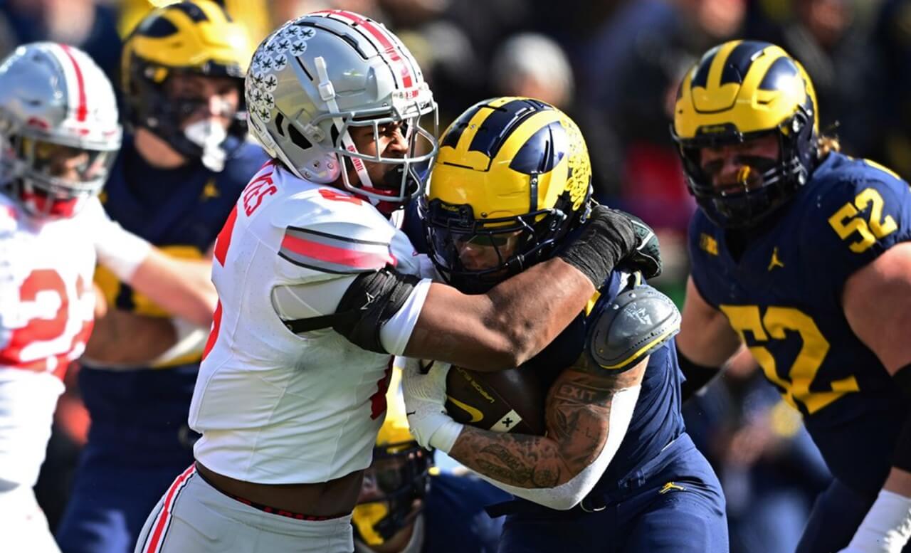 Ohio State Buckeyes celebrate victory over Michigan after 27-9 rivalry win.