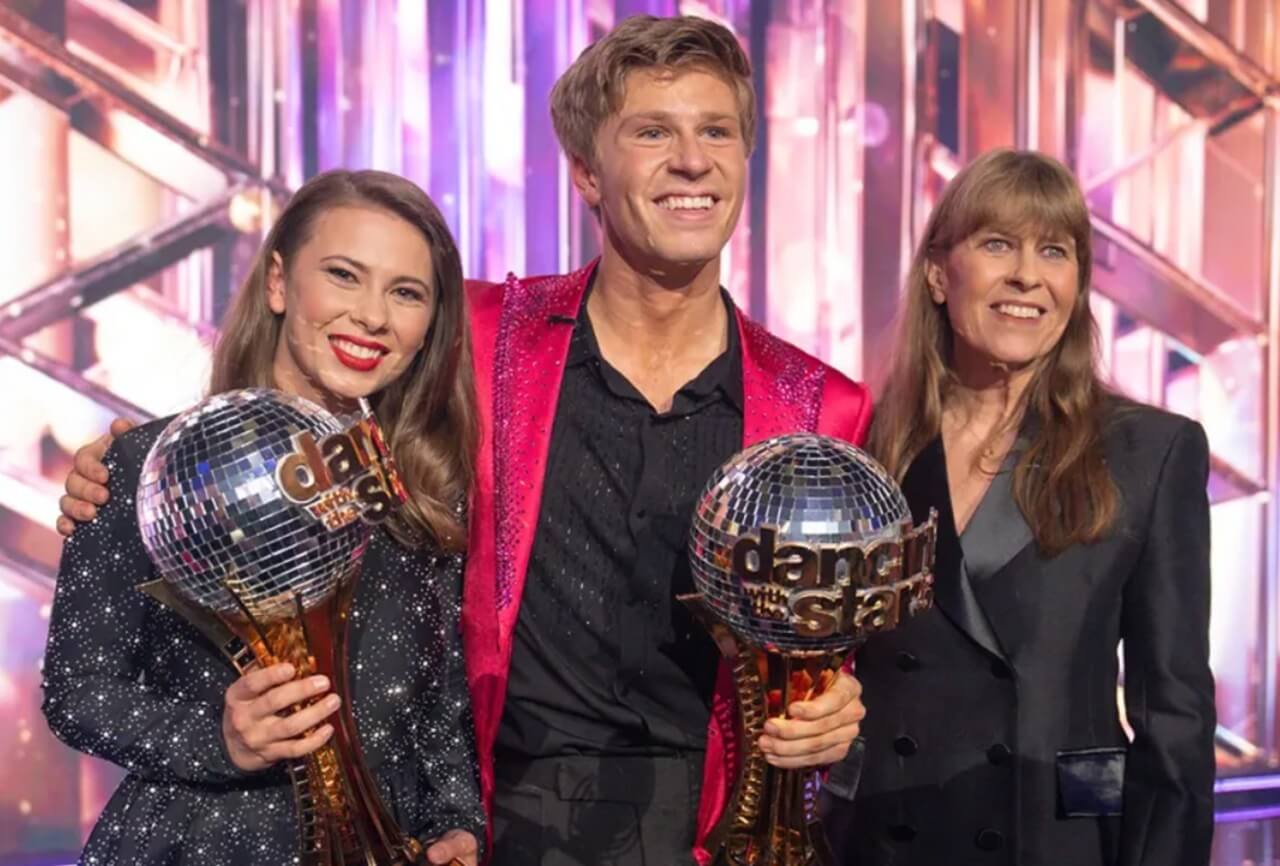Robert Irwin and Witney Carson hold the Mirrorball Trophy after winning Dancing with the Stars Season 34.