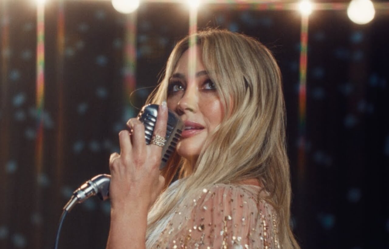 Rosalía singing passionately on stage during her LUX album tour