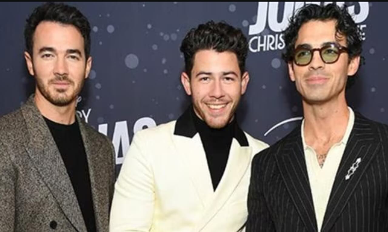 Scott Kelly and Jonas Brothers on The Tonight Show set, November 2025.