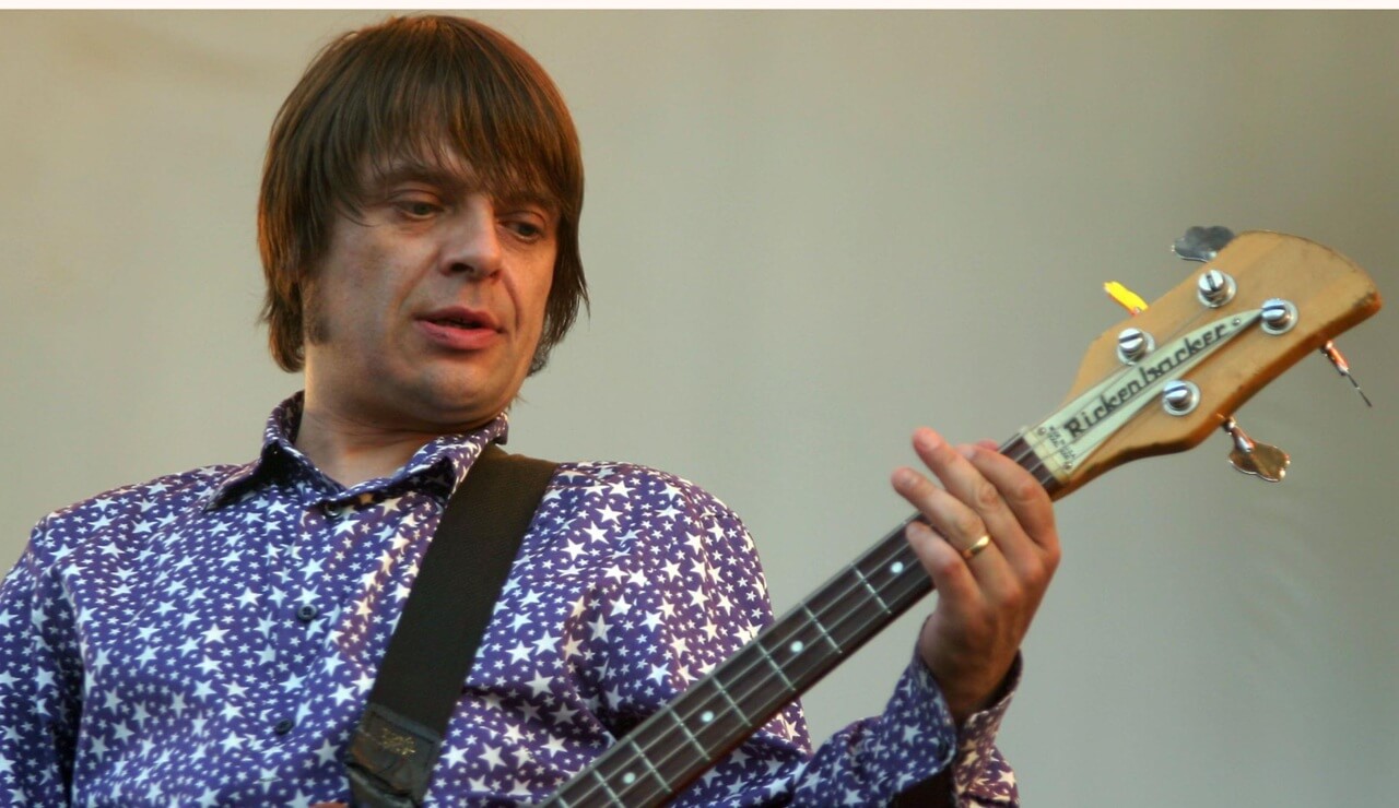 Stone Roses bassist Gary ‘Mani’ Mounfield performing live, remembered as a Manchester music legend.