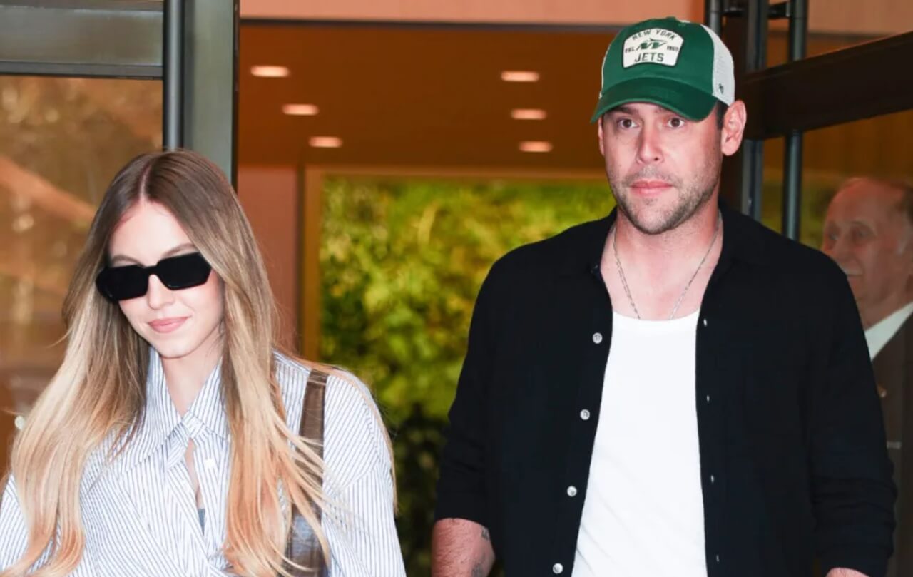 Sydney Sweeney wearing a white swimsuit during poolside PDA moment with Scooter Braun in Florida Keys.