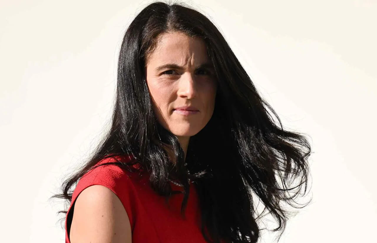 Tatiana Schlossberg speaking at a climate forum, reflecting her role as writer and Kennedy family advocate.