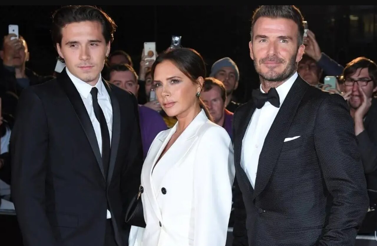 David Beckham receiving knighthood at Windsor Castle with wife and children in attendance.