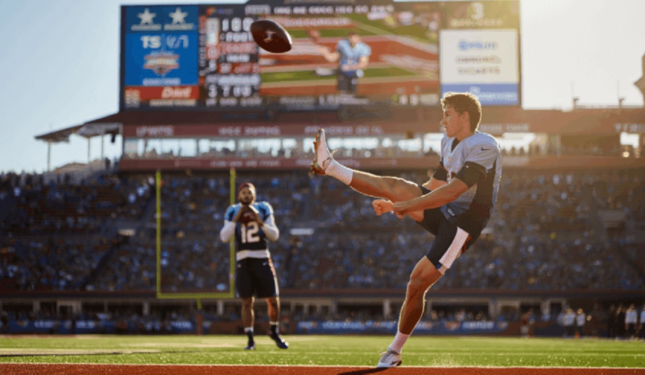 Football player taking a knee in the end zone for a touchback during NFL kickoff