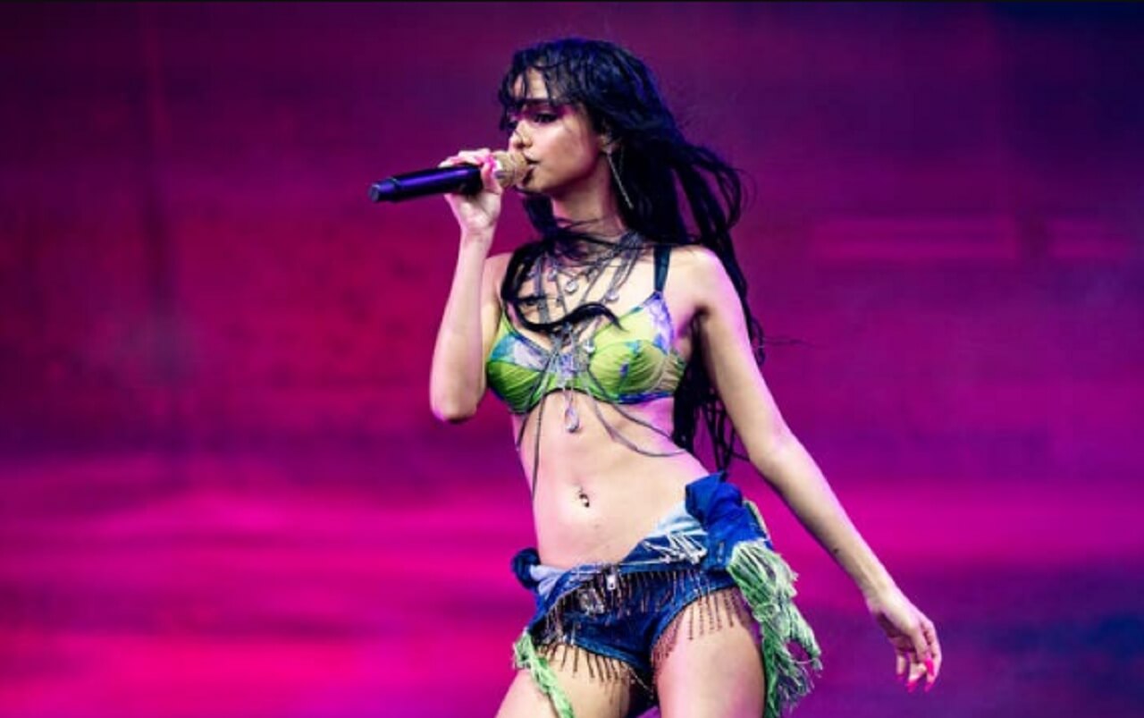 Tyla dances in a neon bra top and shorts with thigh-high boots and a pink bob in her viral video.