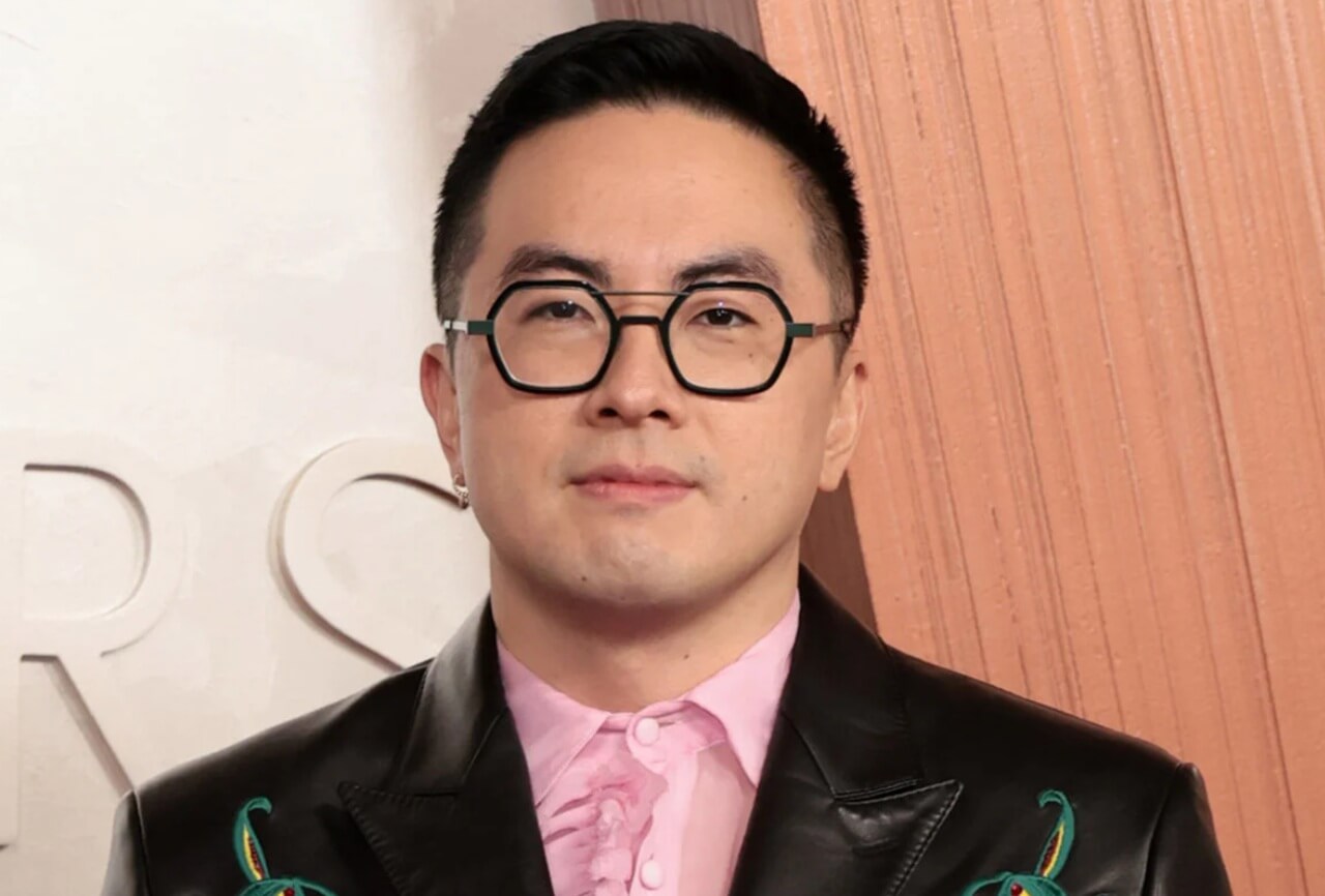 Bowen Yang performing on SNL stage during a live broadcast.