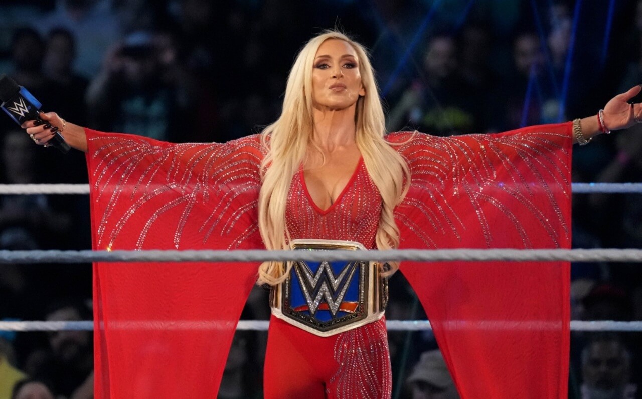 Charlotte Flair in a metallic halter gown posing in a NYC lounge.