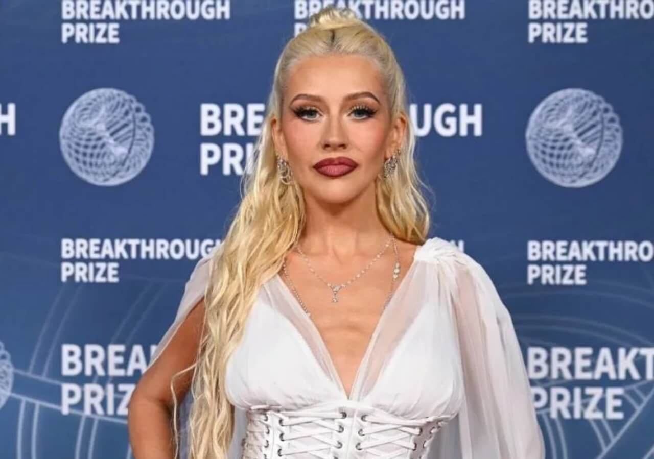 Christina Aguilera in white off-shoulder minidress celebrating her 45th birthday.