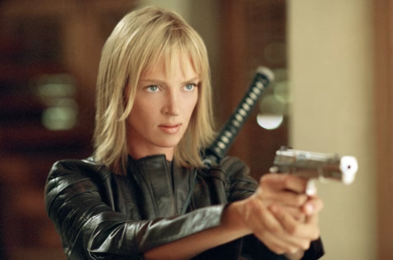 Uma Thurman as The Bride in Kill Bill holding a katana during a fight scene.