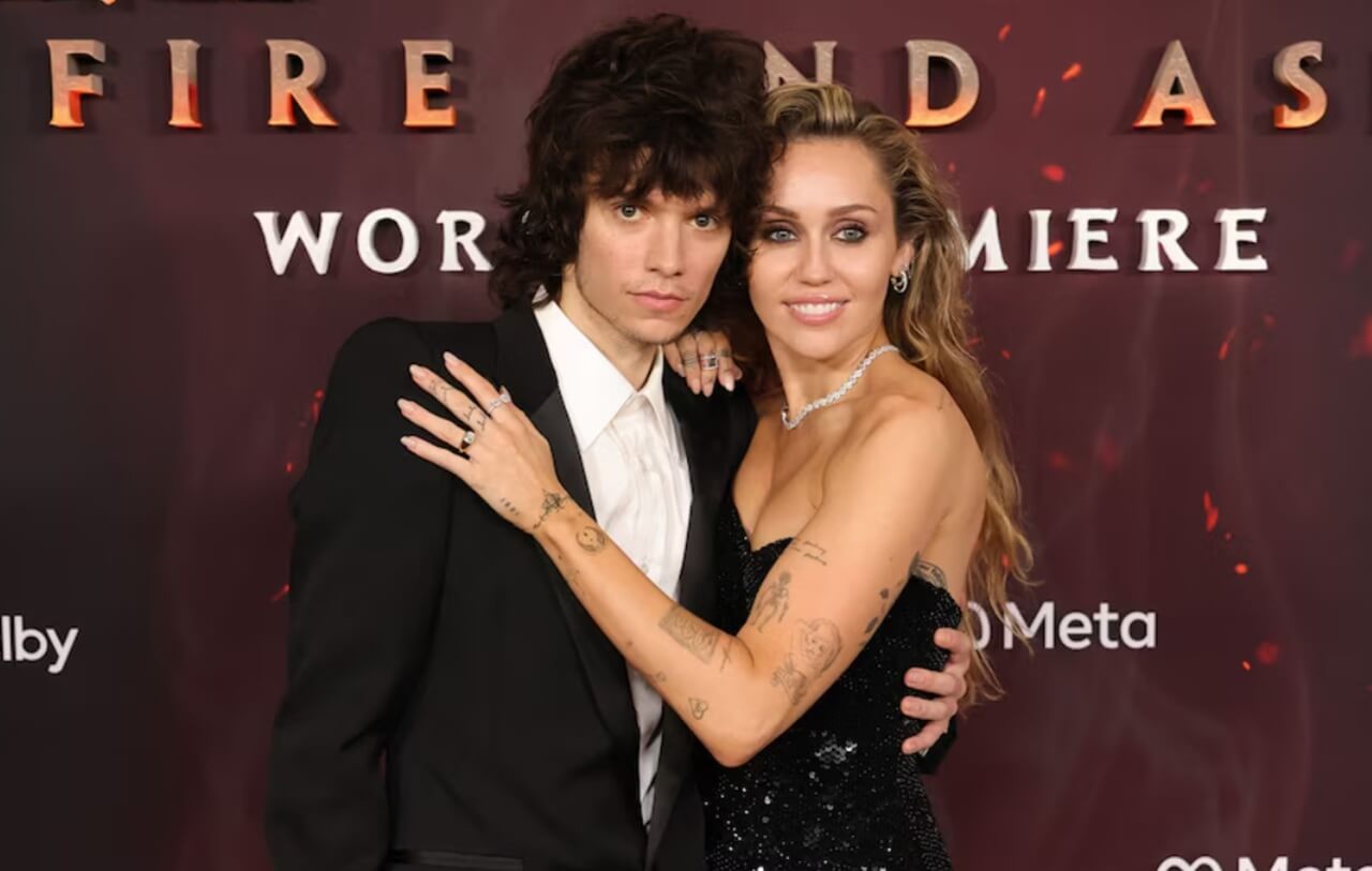 Miley Cyrus and Maxx Morando on the red carpet celebrating their engagement announcement.