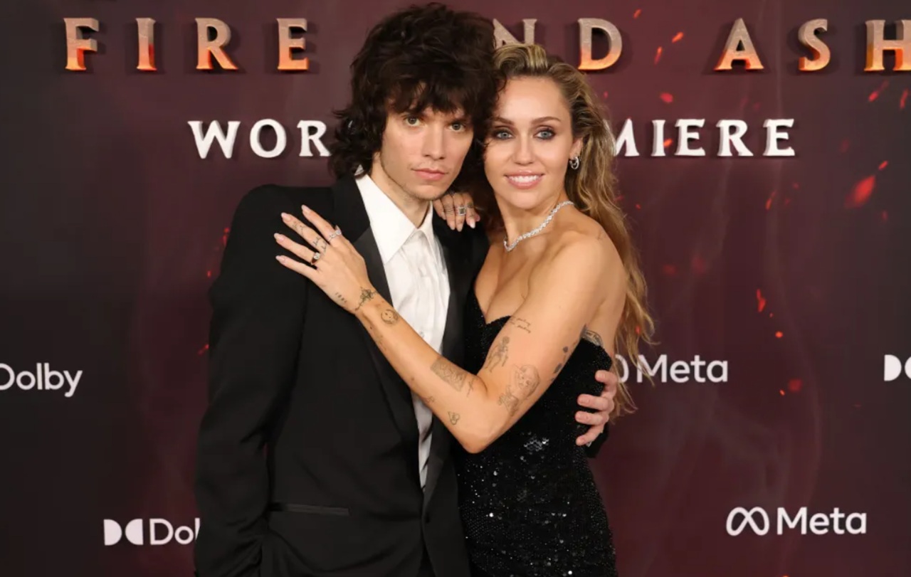 Miley Cyrus and Maxx Morando pose at Hollywood premiere, highlighting Cyrus’ engagement ring.