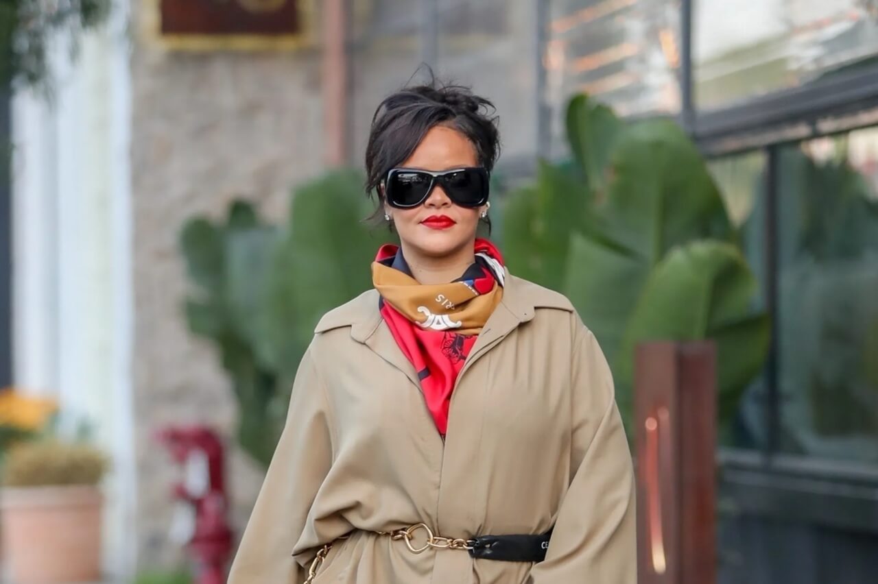 Rihanna wears a trench coat dress with statement accessories in street style look