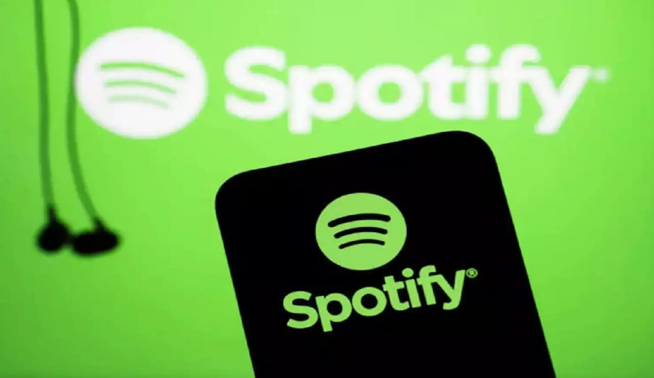 Phone showing Spotify Wrapped recap screen with colorful graphics.