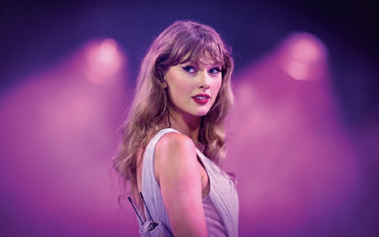 Taylor Swift singing onstage during the final Eras Tour show featured in the new Disney+ concert film.