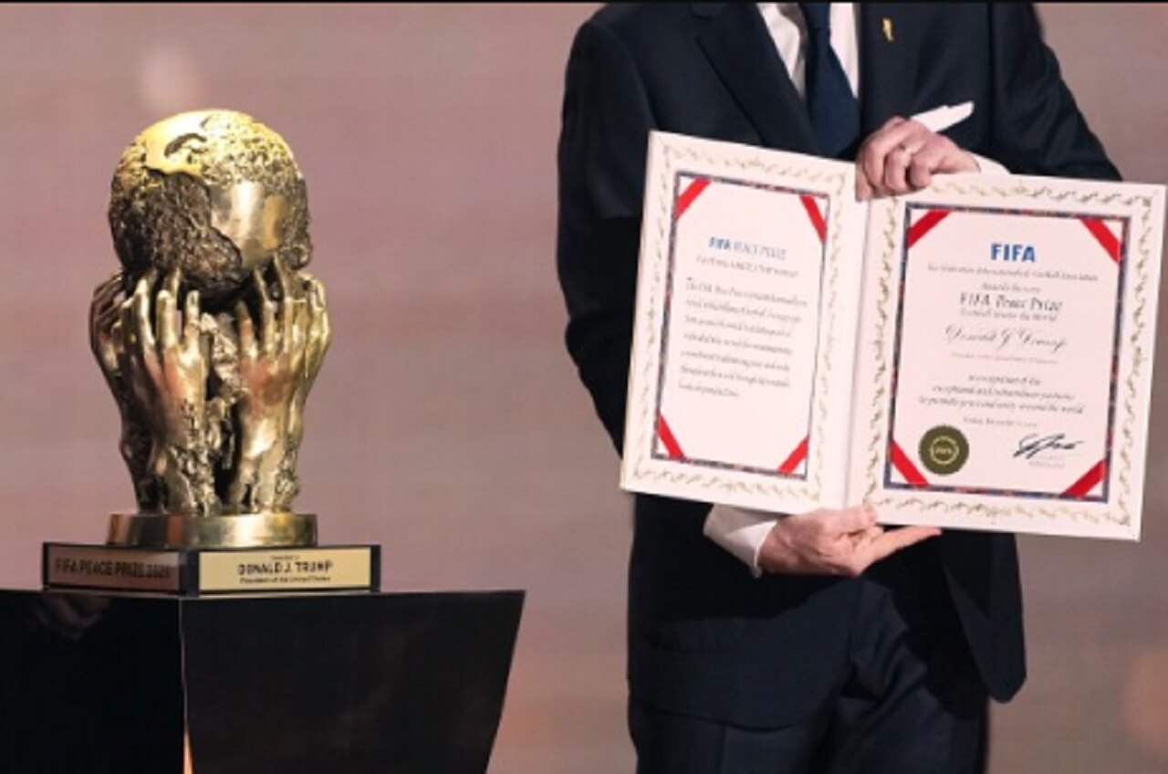 World Cup draw ceremony stage with group matchups displayed on large screens.
