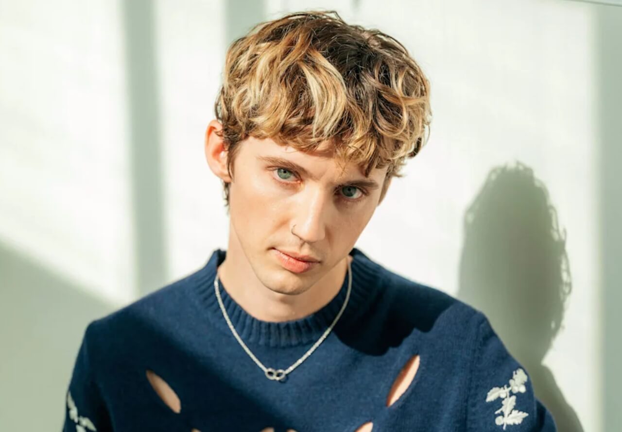 Singer Troye Sivan performing live, responding to cosmetic doctor’s TikTok controversy.
