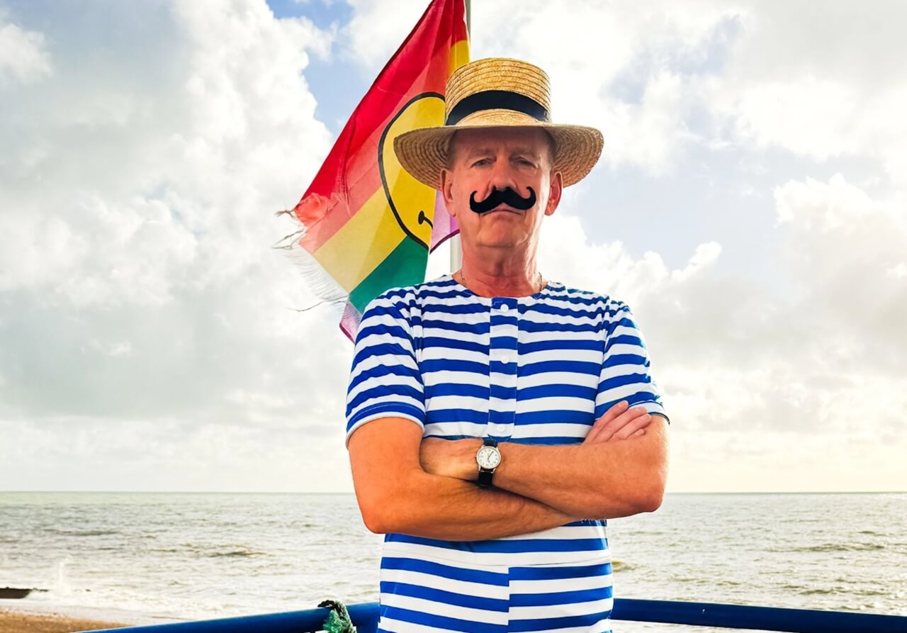 Fatboy Slim on stage at Camp Bestival 2026 with fans cheering at Lulworth Castle.