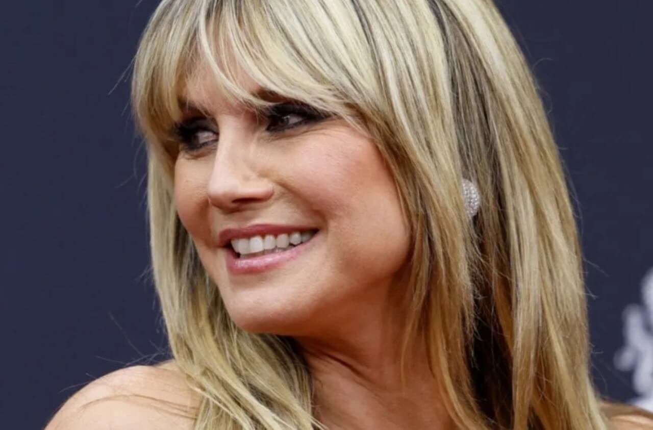 Heidi Klum wearing a cherry-print bikini on the beach in St. Barts