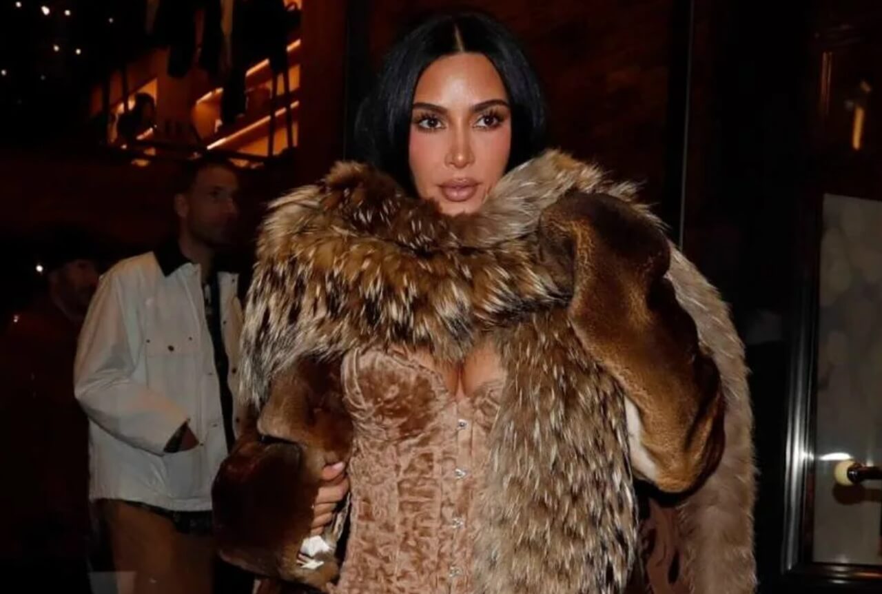 Kim Kardashian wears a fur coat over a bold corset top and leather pants while out in Aspen, Colorado.