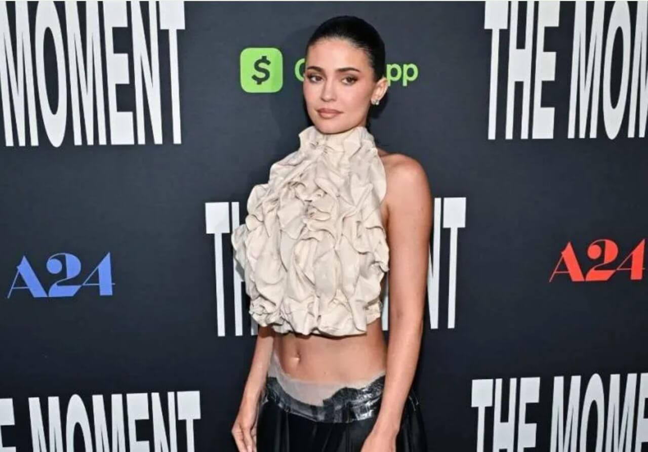 Kylie Jenner in vintage Maison Margiela top with bold cutout and leather skirt.