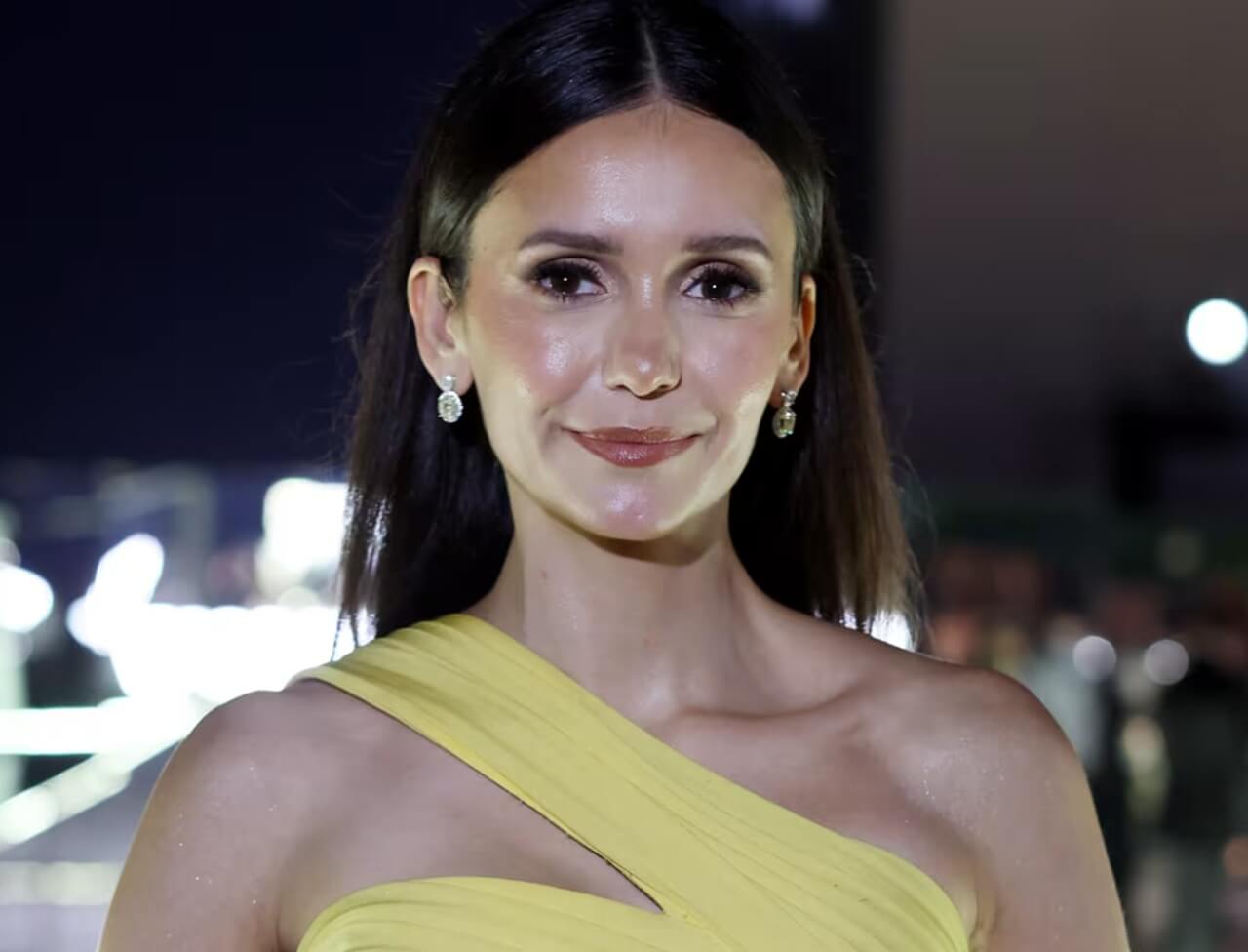 Nina Dobrev in bold black jumpsuit at birthday celebration.