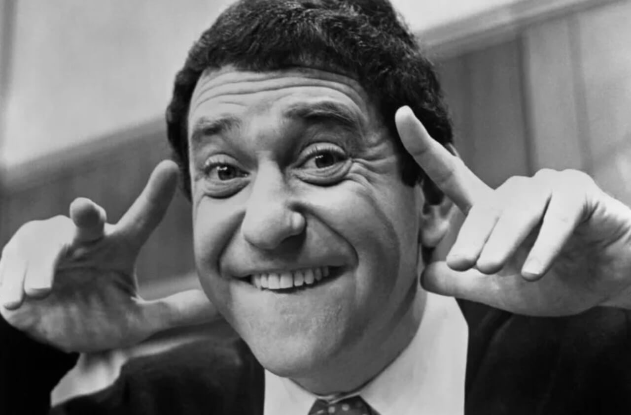 Soupy Sales surrounded by whipped-cream pies on his classic TV show.