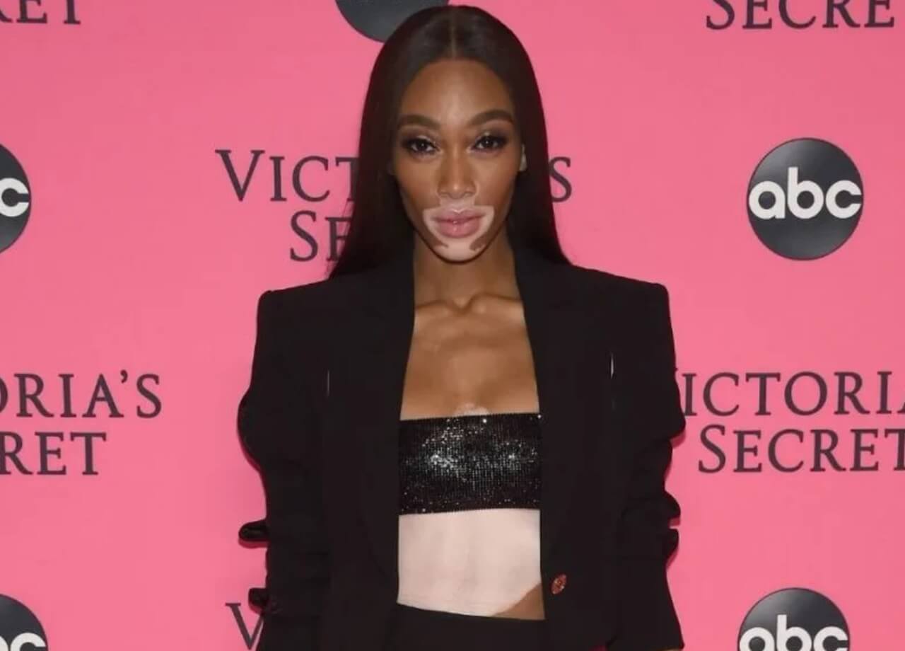 Winnie Harlow stuns in bejeweled lingerie with colorful wings in 2016 throwback photo.