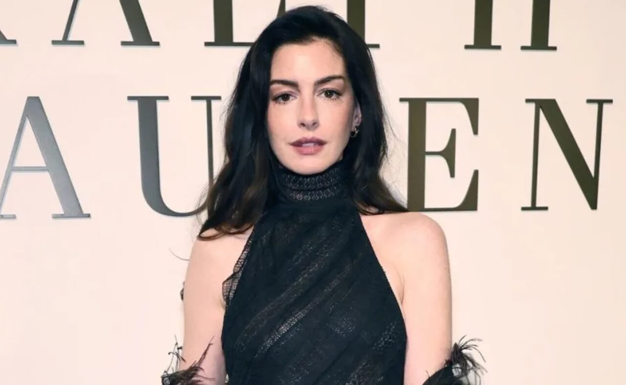 Anne Hathaway in sheer black gown at NYFW Ralph Lauren show.