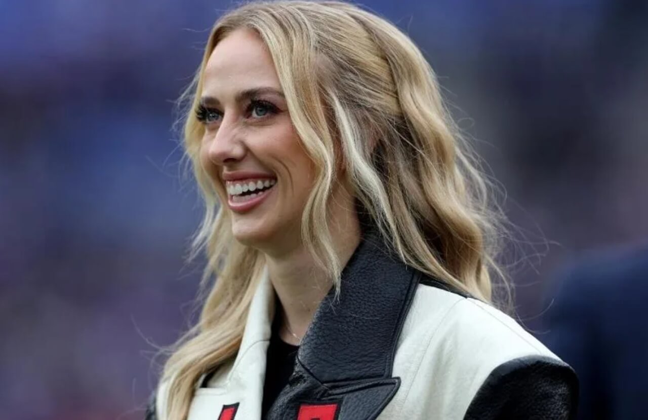 Brittany Mahomes in red bikini with yellow straps for SI Swimsuit 2026 cover.