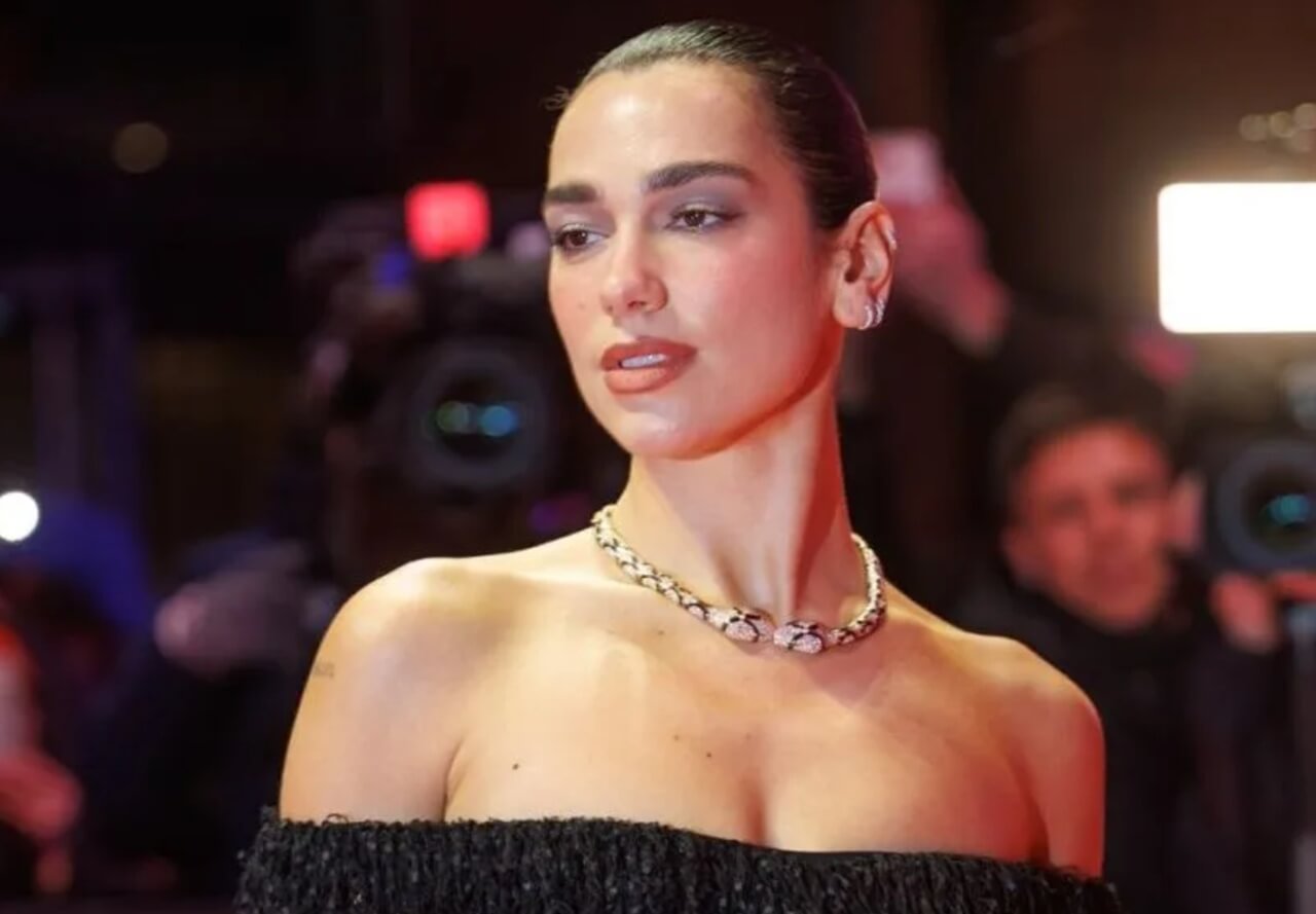 Dua Lipa in Bulgari campaign wearing white shirt and gold jewelry